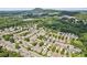 Picturesque aerial view of a residential community surrounded by lush greenery and rolling hills at 3725 Downing Dr, Cumming, GA 30040