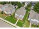 Aerial view showcasing a well-maintained property with a lush green lawn and white picket fence at 3725 Downing Dr, Cumming, GA 30040