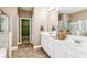 Bright Primary bath with double sink vanity, large mirror, tiled floor, and walk in shower at 3725 Downing Dr, Cumming, GA 30040