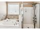 Luxurious bathroom with soaking tub, separate shower, and ample counter space at 3725 Downing Dr, Cumming, GA 30040