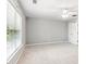 Bedroom features a ceiling fan, large window, and neutral carpet at 3725 Downing Dr, Cumming, GA 30040