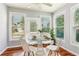 Bright breakfast nook area with a modern table setting, surrounded by sun-drenched windows at 3725 Downing Dr, Cumming, GA 30040