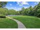 Lush green community lawn with a sidewalk leading to the community tennis courts at 3725 Downing Dr, Cumming, GA 30040