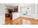 Dining area with a view to the open plan kitchen featuring hardwood floors at 3725 Downing Dr, Cumming, GA 30040