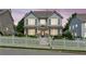 Charming two-story home at dusk featuring a white picket fence, landscaped yard, and inviting front porch at 3725 Downing Dr, Cumming, GA 30040