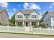 Charming two-story home featuring a white picket fence, landscaped yard, and inviting front porch at 3725 Downing Dr, Cumming, GA 30040