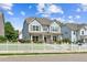 Inviting two-story home featuring a white picket fence, manicured landscaping, and covered front porch at 3725 Downing Dr, Cumming, GA 30040