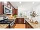 Well-appointed kitchen features granite countertops and stainless steel appliances at 3725 Downing Dr, Cumming, GA 30040