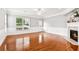 Empty living room with hardwood floors, fireplace, and wainscoting at 3725 Downing Dr, Cumming, GA 30040