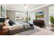 Serene main bedroom boasts neutral tones, large windows, and stylish modern furnishings at 3725 Downing Dr, Cumming, GA 30040