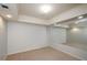 Spacious basement with neutral carpet, recessed lighting, and a large mirror at 4645 Wykeshire Ct, Cumming, GA 30041