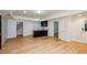 Finished basement featuring vinyl floors, storage cabinet, and walkout at 4645 Wykeshire Ct, Cumming, GA 30041