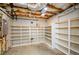 Unfinished basement with storage shelving, bare ceiling, and concrete floor at 4645 Wykeshire Ct, Cumming, GA 30041