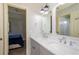 Bathroom featuring double sinks, granite countertops, and a view into a connected bedroom at 4645 Wykeshire Ct, Cumming, GA 30041