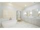Luxurious bathroom with soaking tub, double vanity, marble floors, large mirror and abundant lighting at 4645 Wykeshire Ct, Cumming, GA 30041