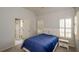 Bedroom featuring comfortable bedding, neutral tones, and ample natural light through shuttered windows at 4645 Wykeshire Ct, Cumming, GA 30041