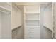 A well-organized walk-in closet with ample shelving, drawers, and hanging space at 4645 Wykeshire Ct, Cumming, GA 30041