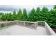 Outdoor deck overlooking the beautifully landscaped backyard with mature trees at 4645 Wykeshire Ct, Cumming, GA 30041