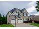 Two-story home boasts a brick facade, dual garage doors, a well-manicured lawn, and basketball hoop at 4645 Wykeshire Ct, Cumming, GA 30041