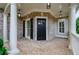 Inviting covered porch with brick flooring and elegant white columns at 4645 Wykeshire Ct, Cumming, GA 30041