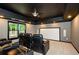 Cozy home theater with tiered seating, ambient lighting, and a ceiling fan at 4645 Wykeshire Ct, Cumming, GA 30041