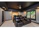 Home theater with comfortable recliner seating, dark ceiling, and theater lighting at 4645 Wykeshire Ct, Cumming, GA 30041