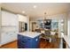 Open kitchen and living space featuring white cabinets, stainless steel appliances, and a central kitchen island at 4645 Wykeshire Ct, Cumming, GA 30041