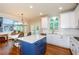 Spacious kitchen featuring white cabinets, stainless steel appliances, and a central island with barstool seating at 4645 Wykeshire Ct, Cumming, GA 30041