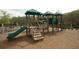 Community playground featuring green slides, jungle gym equipment, wood stairs, and wood chip ground cover at 4645 Wykeshire Ct, Cumming, GA 30041
