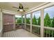 Relaxing screened porch with wooden flooring, ceiling fan, and great outdoor views at 4645 Wykeshire Ct, Cumming, GA 30041