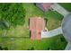 Aerial view of the house with lush green lawns and driveway at 932 Sugar Meadow Ln, Sugar Hill, GA 30518
