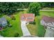 Aerial view of a well-maintained home with a large yard and surrounding trees in a residential area at 932 Sugar Meadow Ln, Sugar Hill, GA 30518