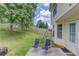 Lovely backyard with patio chairs, playground, and a beautiful wooden fence at 932 Sugar Meadow Ln, Sugar Hill, GA 30518