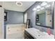 Modern bathroom featuring a soaking tub, vanity with sink, and shower at 932 Sugar Meadow Ln, Sugar Hill, GA 30518