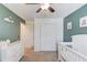 Bright Bedroom with a ceiling fan, closet, and modern color scheme at 932 Sugar Meadow Ln, Sugar Hill, GA 30518