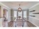 Elegant dining room with stylish light fixture, hardwood floors, and large windows at 932 Sugar Meadow Ln, Sugar Hill, GA 30518