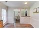 Open-concept view into the dining room with hardwood floors and stylish light fixture at 932 Sugar Meadow Ln, Sugar Hill, GA 30518