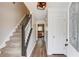 Welcoming foyer featuring hardwood floors, staircase, and an open view into other living spaces at 932 Sugar Meadow Ln, Sugar Hill, GA 30518