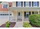 Inviting front porch with white railings, decorative door, and well-kept landscaping at 932 Sugar Meadow Ln, Sugar Hill, GA 30518