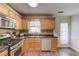 Charming kitchen featuring wood cabinets, a window, and stainless appliances at 932 Sugar Meadow Ln, Sugar Hill, GA 30518