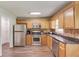 Traditional kitchen with stainless steel appliances and wooden cabinets at 932 Sugar Meadow Ln, Sugar Hill, GA 30518