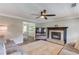 Comfortable living room with fireplace, neutral colors, ceiling fan, and hardwood floors at 932 Sugar Meadow Ln, Sugar Hill, GA 30518