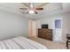 Carpeted main bedroom showcasing dresser, and ensuite bathroom at 932 Sugar Meadow Ln, Sugar Hill, GA 30518