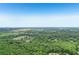 Aerial view showcasing a neighborhood nestled among dense green trees, offering a serene environment at 1181 Chastain Dr, Sugar Hill, GA 30518