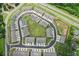 Aerial view of a community features a central green space, modern townhomes, and well-planned street layout, promoting community at 1181 Chastain Dr, Sugar Hill, GA 30518