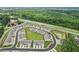 Aerial view of community features modern townhomes around a central green, combining style and community in a desirable location at 1181 Chastain Dr, Sugar Hill, GA 30518