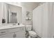 Bathroom with a single sink vanity, toilet, and shower with curtain at 1181 Chastain Dr, Sugar Hill, GA 30518