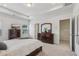 Spacious main bedroom features a tray ceiling, plush carpet, and two windows allowing for natural light at 1181 Chastain Dr, Sugar Hill, GA 30518