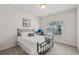 Bedroom showcasing a bed, desk with computer, and outside view at 1181 Chastain Dr, Sugar Hill, GA 30518