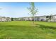Expansive green common area offers a shared outdoor space for the community, enhancing the neighborhood's appeal at 1181 Chastain Dr, Sugar Hill, GA 30518